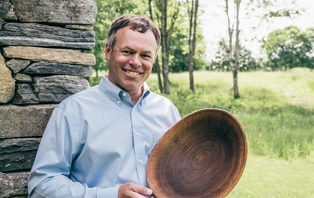 ANDREW PEARCE HOLDING WOODEN BOWL